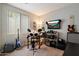 Bedroom features an electric drum set, electric guitars and amp, as well as wall-mounted television at 2328 W Calle Marita --, Phoenix, AZ 85085