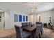 Dining room with stylish lighting fixture and plaid dining chairs at 2328 W Calle Marita --, Phoenix, AZ 85085