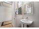 Half bath features decorative mirror and patterned accent wall at 2328 W Calle Marita --, Phoenix, AZ 85085