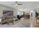 Open concept living room and kitchen with ceiling fan, comfortable seating and eat-in bar at 2328 W Calle Marita --, Phoenix, AZ 85085