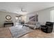Neutral-toned living room features a ceiling fan, plush rug, comfortable seating and sliding door to outside at 2328 W Calle Marita --, Phoenix, AZ 85085