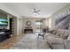 Spacious living room featuring neutral tones, a ceiling fan, plush rug and sliding door to outside at 2328 W Calle Marita --, Phoenix, AZ 85085