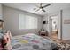 Inviting bedroom features a ceiling fan, a sitting area, and natural light at 2328 W Calle Marita --, Phoenix, AZ 85085