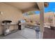 Spacious covered patio with a grill, overlooking the private backyard and desert landscaping at 2328 W Calle Marita --, Phoenix, AZ 85085