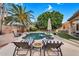 Serene backyard featuring a sparkling pool, mature trees, and outdoor seating at 2440 E Stephens Pl, Chandler, AZ 85225