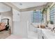 Bright bathroom showcases a walk-in shower with glass block window and convenient handrails for added accessibility at 2440 E Stephens Pl, Chandler, AZ 85225