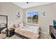 Bedroom with neutral walls, window view, and cozy bed, creating a serene and inviting atmosphere at 2440 E Stephens Pl, Chandler, AZ 85225