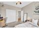 Bedroom features neutral walls, plush carpet, and a cozy bed with small work space at 2440 E Stephens Pl, Chandler, AZ 85225