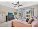 Inviting bedroom with plush carpet, neutral walls, and light-filled windows, complete with ceiling fan and dresser at 2440 E Stephens Pl, Chandler, AZ 85225