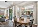 The dining area features an oversized round table and chairs next to sliding doors to the pool at 2440 E Stephens Pl, Chandler, AZ 85225