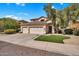 Charming home with a three-car garage and manicured front yard under a bright blue sky at 2440 E Stephens Pl, Chandler, AZ 85225