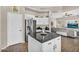 This view of the kitchen showcases stainless steel appliances and a black granite island at 2440 E Stephens Pl, Chandler, AZ 85225