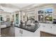Bright kitchen boasts an island with a dark countertop and white cabinets and views to the backyard at 2440 E Stephens Pl, Chandler, AZ 85225