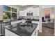 This kitchen includes a dark countertop island, stainless steel appliances, and an open concept living space at 2440 E Stephens Pl, Chandler, AZ 85225