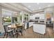 Bright eat-in kitchen features white cabinets, a black countertop, and views to the pool at 2440 E Stephens Pl, Chandler, AZ 85225