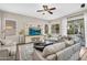 Spacious living room with bright windows, stylish decor, and access to the backyard and pool at 2440 E Stephens Pl, Chandler, AZ 85225