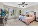 Main bedroom with ample natural light, a ceiling fan, and neutral colored carpet at 2440 E Stephens Pl, Chandler, AZ 85225
