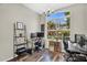 Bright home office featuring a large window, modern decor, and ample workspace for productivity at 2440 E Stephens Pl, Chandler, AZ 85225