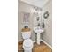 Quaint powder room with unique fixtures, décor, and a pedestal sink at 2440 E Stephens Pl, Chandler, AZ 85225