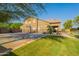 Large backyard features basketball court, lush lawn and mature landscaping at 2735 E Flower Ct, Gilbert, AZ 85298