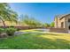 Green lawn, backyard basketball court, and landscaping creates a beautiful outdoor oasis at 2735 E Flower Ct, Gilbert, AZ 85298