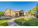 Expansive backyard featuring a pool, patio, basketball court, and lush green lawn for outdoor enjoyment at 2735 E Flower Ct, Gilbert, AZ 85298