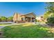 Expansive backyard featuring a pool, patio, basketball court, and lush green lawn for outdoor enjoyment at 2735 E Flower Ct, Gilbert, AZ 85298