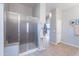 Bright bathroom featuring tiled floors, glass shower, neutral paint, and access to vanity sink at 2735 E Flower Ct, Gilbert, AZ 85298