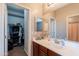 Bathroom featuring vanity with drawers, sink, mirror, and walk in closet at 2735 E Flower Ct, Gilbert, AZ 85298