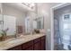Bathroom featuring a double sink vanity with granite countertops and a large mirror at 2735 E Flower Ct, Gilbert, AZ 85298
