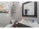 Bathroom featuring a vanity with marble countertop, decorative shelving, a toilet and a mirror at 2735 E Flower Ct, Gilbert, AZ 85298