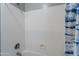 Close up on bathtub and shower with white tiling and silver showerhead at 2735 E Flower Ct, Gilbert, AZ 85298