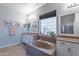 Spacious bathroom features double sinks, soaking tub with granite counters, and glass block window at 2735 E Flower Ct, Gilbert, AZ 85298
