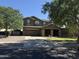Inviting two-story home with a spacious driveway, beautiful stone accents and lush, green lawn at 2735 E Flower Ct, Gilbert, AZ 85298