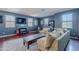 Game room with a sectional, hardwood floors, dark blue walls, television, recessed lights and many windows at 2735 E Flower Ct, Gilbert, AZ 85298