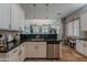 Bright kitchen featuring white cabinets, granite countertops, and stainless steel appliances at 2735 E Flower Ct, Gilbert, AZ 85298