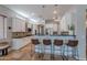 Charming kitchen with bright, white cabinets, a black countertop, stainless steel appliances and modern lighting at 2735 E Flower Ct, Gilbert, AZ 85298