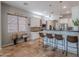 Charming kitchen with bright, white cabinets, a black countertop, stainless steel appliances and modern lighting at 2735 E Flower Ct, Gilbert, AZ 85298
