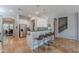 Charming kitchen with bright, white cabinets, a black countertop, stainless steel appliances and modern lighting at 2735 E Flower Ct, Gilbert, AZ 85298