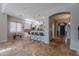 Open-concept kitchen with bar seating, white cabinetry, stone floors, and views of the home's entry at 2735 E Flower Ct, Gilbert, AZ 85298