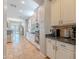 Spacious kitchen with stone floors, white cabinets, and stainless steel appliances at 2735 E Flower Ct, Gilbert, AZ 85298