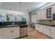 Inviting kitchen featuring white cabinets, stainless steel appliances, and stylish pendant lighting at 2735 E Flower Ct, Gilbert, AZ 85298