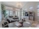 Spacious living room with tall ceilings, large windows, and comfortable furniture is perfect for relaxing or entertaining at 2735 E Flower Ct, Gilbert, AZ 85298