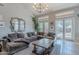 Spacious living room with tall ceilings, large windows, and comfortable furniture is perfect for relaxing or entertaining at 2735 E Flower Ct, Gilbert, AZ 85298