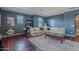 Comfortable living area with a large sofa, a coffee table, and dark wood flooring at 2735 E Flower Ct, Gilbert, AZ 85298