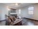 Comfortable lounge area with hardwood floors, a stylish couch, and a convenient beverage fridge at 2735 E Flower Ct, Gilbert, AZ 85298