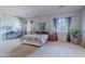 Large main bedroom with a canopy bed, neutral carpet and curtains at 2735 E Flower Ct, Gilbert, AZ 85298
