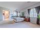 Spacious main bedroom with a canopy bed, en-suite bathroom and decorative accents at 2735 E Flower Ct, Gilbert, AZ 85298