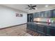 Well-lit home office with custom built-ins, shelving, and a spacious desk area at 2735 E Flower Ct, Gilbert, AZ 85298