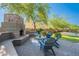Cozy outdoor fireplace with seating area and patio, perfect for relaxing and entertaining guests at 2735 E Flower Ct, Gilbert, AZ 85298